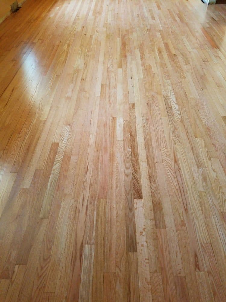 Light hardwood flooring in a spacious room with natural light.